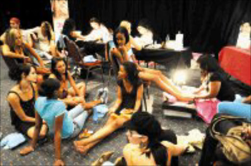 LAST TOUCH: Miss SA and Miss SA Teen finalists having their nails and hair done during rehearsals for the pageant to be held tomorrow. © Sowetan.