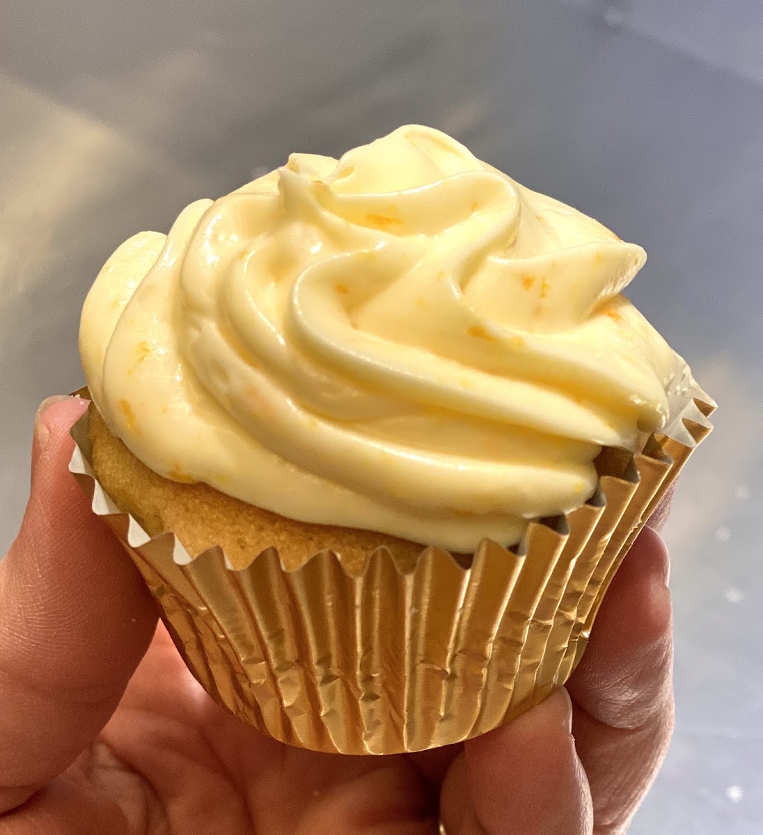 Vanilla cupcake with orange butter cream frosting