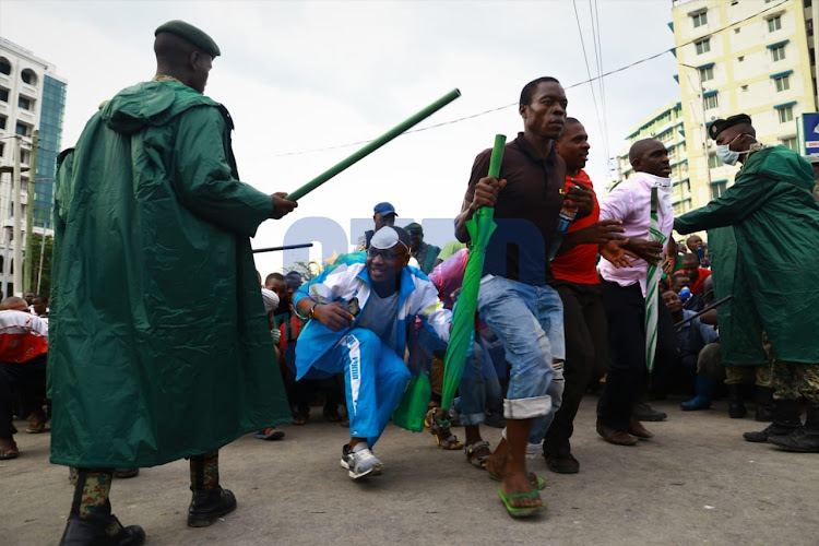 Mombasa residents scamper for safety as police enforce the nationwide curfew on March 27