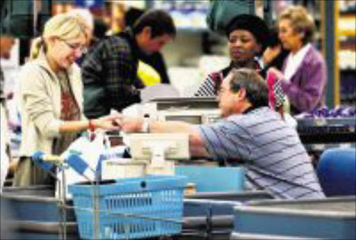 RELIEF: Economists expect a drop in food prices in the next four months. Pic: Terry Shean. 23/07/2009. © Sunday Times. Leon Wilks, part of Pick'n Pay management, helped on the tills in the sea point supermarket after the SA catering and allied workers union called a strike. Pic: TERRY SHEAN. 23/07/05. © Sunday Times. ------ times week pics ful col max size