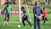 Bafana Bafana head coach Stuart Baxter keeps an eye on left back Sfiso Hlanti (L) striker Percy Tau (C) and midfielder Siphesihle Ndlovu during the South Africa training session at Princess Magogo Stadium on September 3 2018.