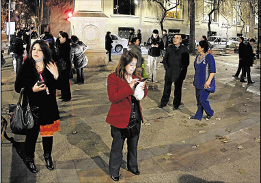 BADLY SHAKEN: A group of people gather in a small square after a quake in Santiago on Wednesday. A strong earthquake of magnitude 8.3 rattled the Chilean capital and other regions of the country. Picture: EPA
