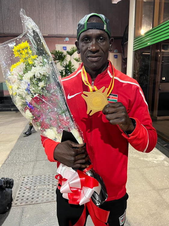 Wilson Okong'o displays his medal after arrival from the African Games in Accra, Tokyo