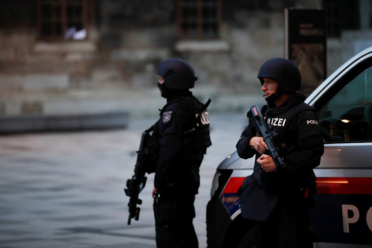 Police officers stand guard after exchanges of gunfire in Vienna, Austria November 3, 2020.