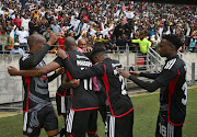 Orlando Pirates players celebrate Tapelo Xoki's goal during the Nedbank Cup semifinal against Chippa United at Nelson Mandela Bay Stadium.