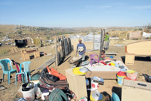 STARTING UP AGAIN: Families at KwaRay near Mthatha, start rebuilding shacks after officials from King Sabata Dalindyebo municipality demolished their homes on Wednesday after a failed court bid to prevent them from doing so Pictue: SUPPLIED