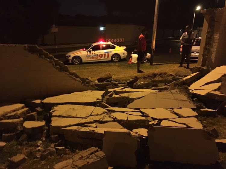 Paramedics on the scene of a crash where a car ploughed through a wall in Sandton