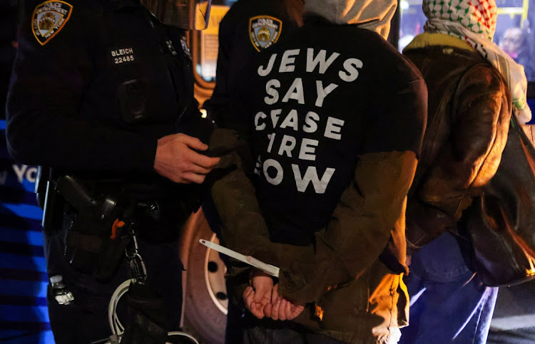 A police officer detains a protester after blocking a street during a protest demanding the US government to stop arming Israel, during the ongoing conflict between Israel and Hamas, in the Brooklyn borough of New York City, US, on April 23 2024.