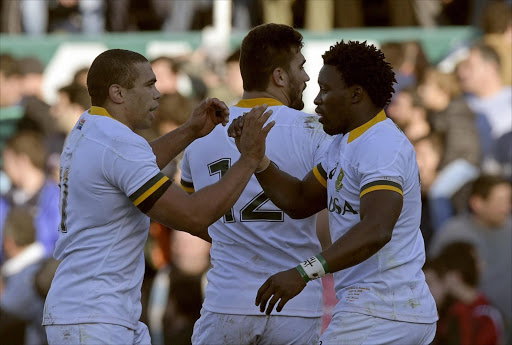 Springboks wing Lwazi Mvovo celebrates with teammates wing Bryan Habana and centre Damian de Allende after scoring a try against Argentina's Los Pumas during their 2015 Rugby World Cup warm-up match at Jose Amalfitani stadium in Buenos Aires, Argentina on August 15, 2015. Picture credits: AFP