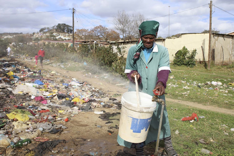 Welekazi Makina, 71, who resides at Tantyi, Makhanda, tries to get water from a broken community tap located at a dump site. Early this year, young and old members of the Makhanda community protested and blocked the streets in town demanding better services and blamed the municipality for not delivering on its promises.