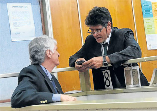 STRATEGISING: Neil Pieter le Roux and his counsel, advocate Neil Schoeman, talk during a short court adjournment yesterday Picture: ZWANGA MUKHUTHU