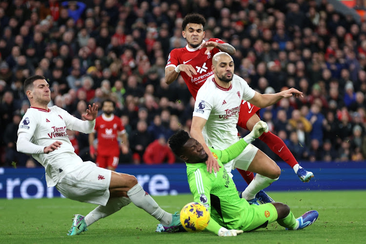 Luis Diaz of Liverpool has a shot blocked by Sofyan Amrabat and goalkeeper Andre Onana of Manchester United in the Premier League match at Anfield in Liverpool on Sunday.