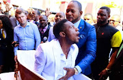 The video of 'resurrected' Brighton Moyo and Alph Lukau has gone viral, sparking a challenge on Twitter. According to Moyo's former boss '... he was in a wheelchair once before and they got him to stand and walk'.