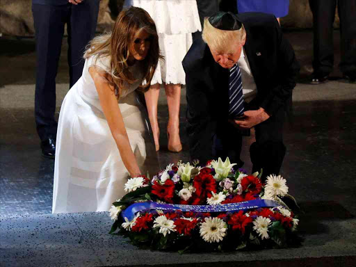 US President Donald Trump and first lady Melania lay a wreath during a ceremony commemorating the six million Jews killed by the Nazis in the Holocaust, in the Hall of Remembrance at Yad Vashem Holocaust memorial in Jerusalem May 23, 2017. /REUTERS