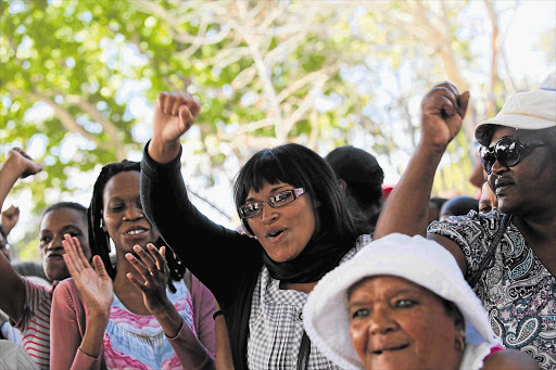 Fatima Charles, centre, celebrates after charges against her and 40 other people were dropped yesterday. Forty-one people were arrested on Friday as they were participating in a demonstration 'Occupy Rondebosch Common'. Police sprayed blue dye on the crowd Picture: SHELLEY CHRISTIANS