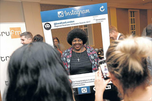 BUSINESS NARRATIVE: Guest Titana Mveve poses with the Instagram board at the Regional Business Achievers Awards at Hemingways Mall Picture: MARK ANDREWS