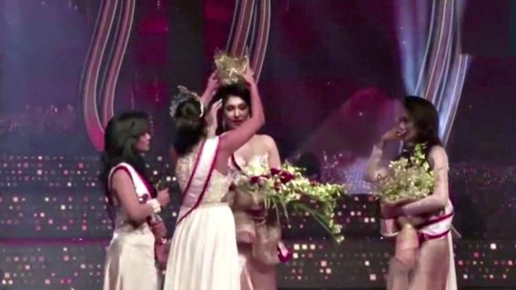 Pushpika De Silva's crown is removed from her head by the reigning Mrs World, Caroline Jurie, after Jurie declared that De Silva was ineligible to win the Mrs Sri Lanka pageant on April 4 2021.