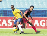 DEADLOCK:  Siyabonga Ngubane of Mamelodi Sundowns is challenged by Matthew Rusike of Jomo Cosmos. photo: BackpagePix