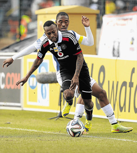 DIRE AFFAIR: Mpho Makola of Pirates shields the ball from Wits captain Sibusiso Vilakazi during the first leg of an uninspired MTN8 semi-final in Johannesburg yesterday