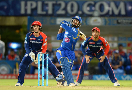 A file photo of Mumbai Indians batsman Krunal Pandya (C) being watched by Delhi Daredevils wicketkeeper Quinton de Kock(L) and fielder Delhi Daredevils Jean-Paul Duminy (R) as he plays a shot during the 2016 Indian Premier League (IPL) Twenty20 cricket match between Mumbai Indians and Delhi Daredevils at Dr.Y.S. Rajasekhara Reddy ACA-VDCA Cricket Stadium in Visakhapatnam on May 15, 2016.