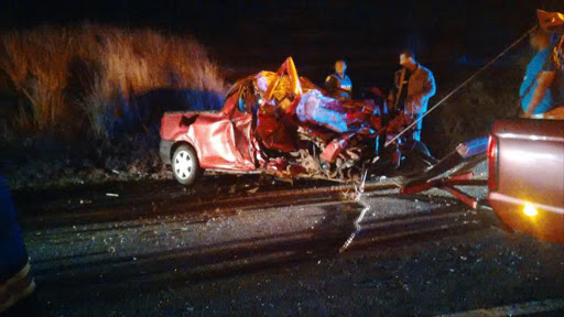 MANGLED: A Nissan NP200 bakkie, which collided with two huge trucks on the N2 shortly before midnight on the N2 between Mount Ayliff and Mount Frere, is towed away. Three of its occupants, a father and his two young children, were killed on the spot while his wife was flung out of the car. She was airlifted to the Nelson Mandela Central Hospital in Mthatha Picture: SUPPLIED