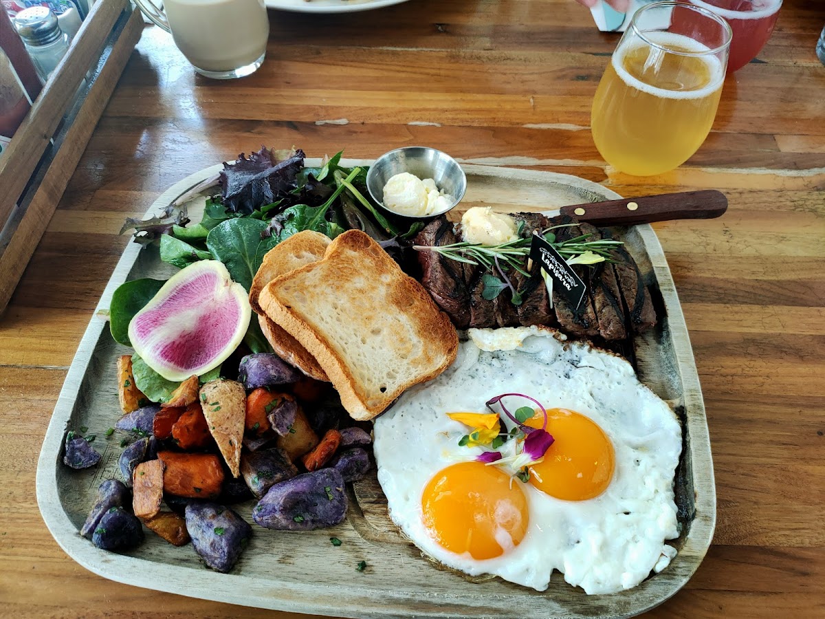 Steak, eggs, potatoes and salad