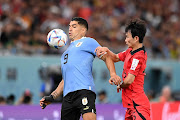 Luis Suarez of Uruguay controls the ball against Moonhwan Kim of Korea Republic in their World Cup Group H match at Education City Stadium in Al Rayyan, Qatar on November 24 2022.