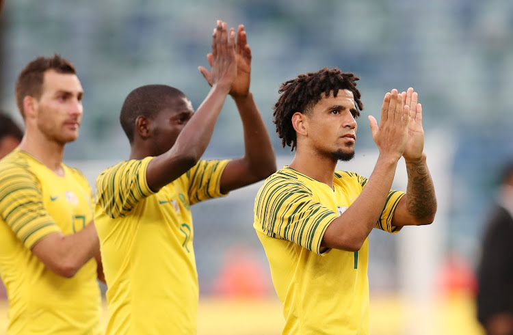 Bafana Bafana players Bradley Grobler (L), Maphosa Modiba (C) and Keagan Dolly (R) applaud the fans after their 2019 Africa Cup of Nations qualifying match against Libya at the Moses Mabhida Stadium in Durban on September 8 2018.