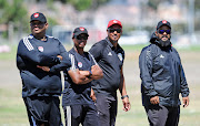 The Magic FC technical team from left to right: Assistant coach Zane Alexander, head coach David Kannemeyer, assistant Zane Ryklief and goalkeeper coach Shivaan Sayed look on during a training session at Royal Road Fields in Cape Town on February 12 2019.   