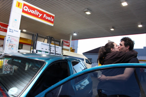 HAPPY TIMES: Morgan De Beer and fiancee Cassey Voogte embrace after Voogte said 'I do' at a Cambridge filling station Picture: SISIPHO ZAMXAKA