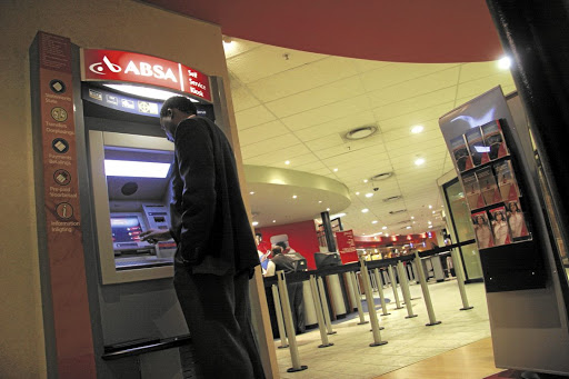 A man withdraws cash from an Absa ATM in Johannesburg.