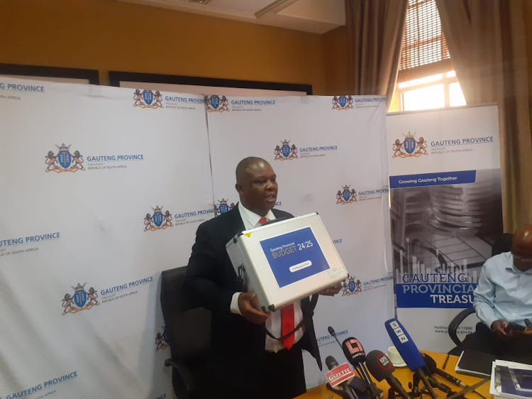 Gauteng finance MEC Jacob Mamabolo shows the briefcase containing budget documents to be tabled in the legislature.