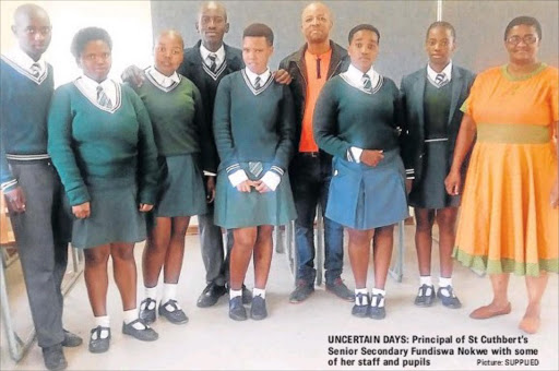 UNCERTAIN DAYS: Principal of St Cuthbert’s Senior Secondary Fundiswa Nokwe with some of her staff and pupils Picture: SUPPLIED