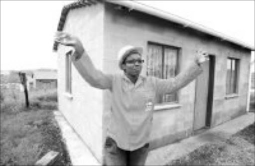 HOUSEPROUD: One of the overjoyed women who took possession of her own home yesterday. Pic. Mandla Mkhize. © Sowetan.
