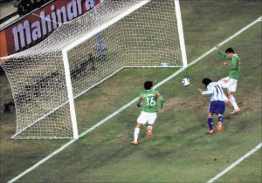 IN THE NET: Argentina's Carlos Tevez scores a goal against Mexico during the two teams' second round World Cup clash at Soccer City. Pic. VATHISWA RUSELO. 27/06/2010. © Sowetan Argentina's Carlos Tevez scores a goal against Meico during the two teams' second round World Cup clash at Soccer City. PHPOTO: VATHISWA RUSELO