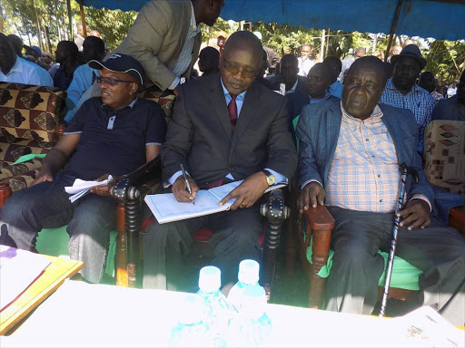 South Mugirango MP Manson Nyamweya, Governor James Ongwae and county public service board chairman David Kombo in a funeral on Friday.Photo/BENSON NYAGESIBA