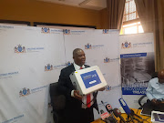 Gauteng finance MEC Jacob Mamabolo shows the briefcase containing budget documents to be tabled in the legislature.