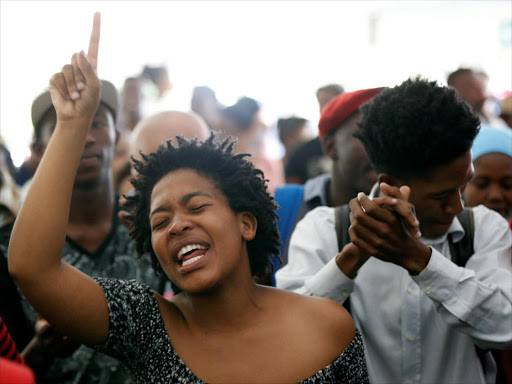 Students sing struggle songs during a gathering as Academic staff and church leaders protest demanding free tertiary education at Johannesburg's University of the Witwatersrand, South Africa, October 7, 2016. /REUTERS