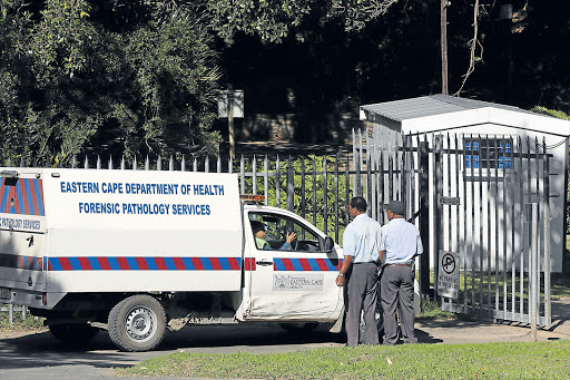 GRUESOME TASK: A forensic pathology team arrives at the East London Zoo, where a man was mauled to death in the lions’ den. INSET: The lion enclosure that the man climbed into Pictures: ALAN EASON