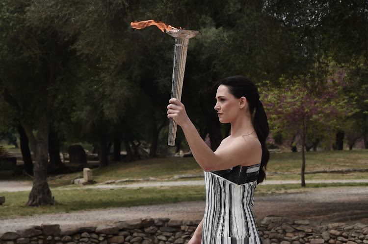Actor Mary Mina carries the torch during the flame-lighting ceremony for the Paris 2024 Summer Olympics at the Olympia archeological site in southern Greece, April 16 2024. Picture: MILOS BICANSKI/GETTY IMAGES