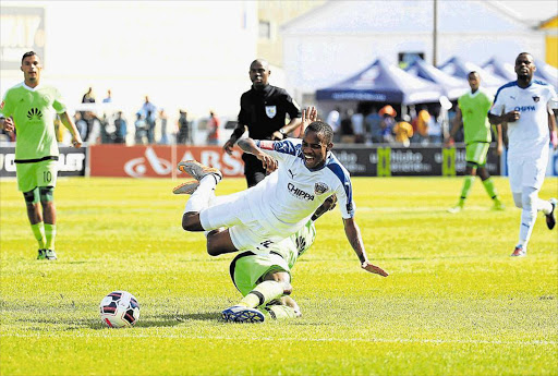 SLICING THE JALAPENO: Joseph Molangoane of Chippa United is tackled by an Ajax player during the match in East London Picture: STEPHANIE LLOYD