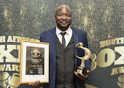 Promoter Ayanda Matiti with the trophy and certificate he received as Promoter of the Year in 2023. 