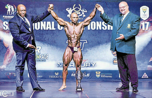 THE MAIN MAN: Mveliso Tapi, flanked by Bodybuilding South Africa vice-president Kaya Majeke, left, and president Wayne Price is crowned Mr South Africa at the 2017 IFBB SA Champs in Mpumalanga last weekend