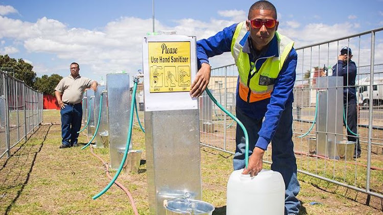 Brandon Herringer, a City of Cape Town plumber, demonstrates how a water point works if day zero in Cape Town had happened.