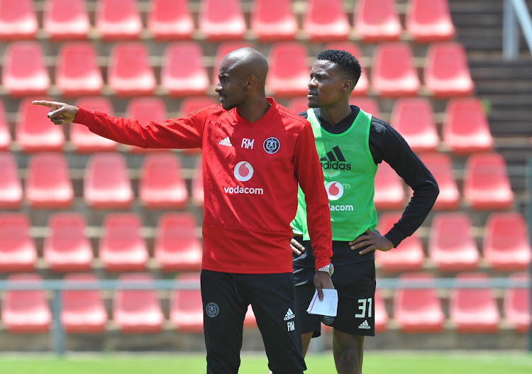 Orlando Pirates' assistant coach Rulani Mokwena and striker Thamsanqa Gabuza look on during a training session at the club's base at Rand Stadium in Johannesburg on Monday October 22, 2018.