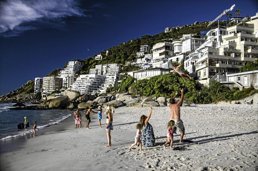 UP IN THE AIR: Tourists and locals enjoy Clifton Beach in Cape Town. Buyers and investors at the top end are now very hesitant to transact.