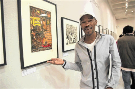 DEEP-ROOTED MESSAGE: Artist Xolile Mtakatya points at some of his works at an exhibition and book launch at the Bellville Library, Cape Town, on Tuesday night. PHOTO: Mathews Mfubu