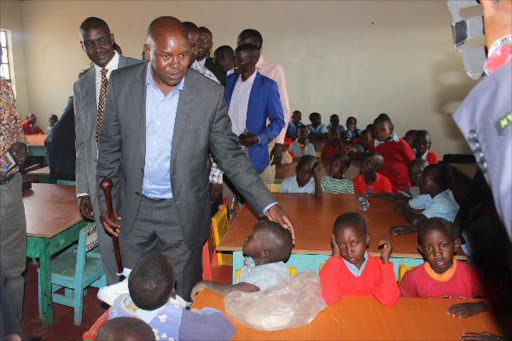Governor David Nkedianye at Kerero ECD centre in Namanga where he distributed shoes from the county government on Thursday. He told the Maasai people yesterday to stop selling land.Photo/Kurgat Marindany