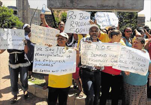 NOT HAPPY: Staff at the Grahamstown education department district office protest outside the building yesterday