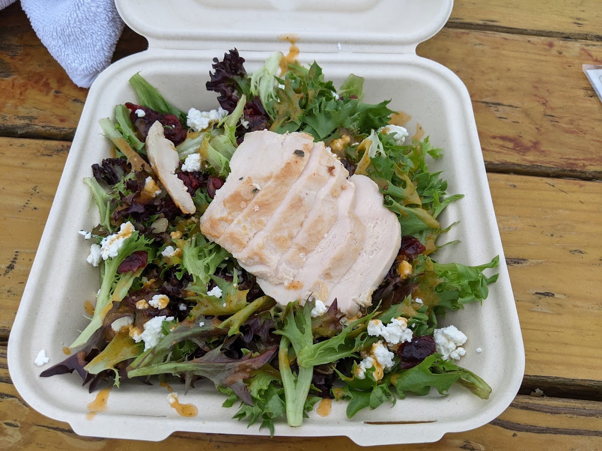 $13 salad with grilled chicken, goat cheese, and dried cranberries